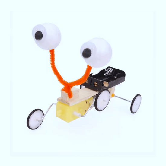 Wobbly Eyes kit components laid out — servo motor, wooden frame, and eye mechanism