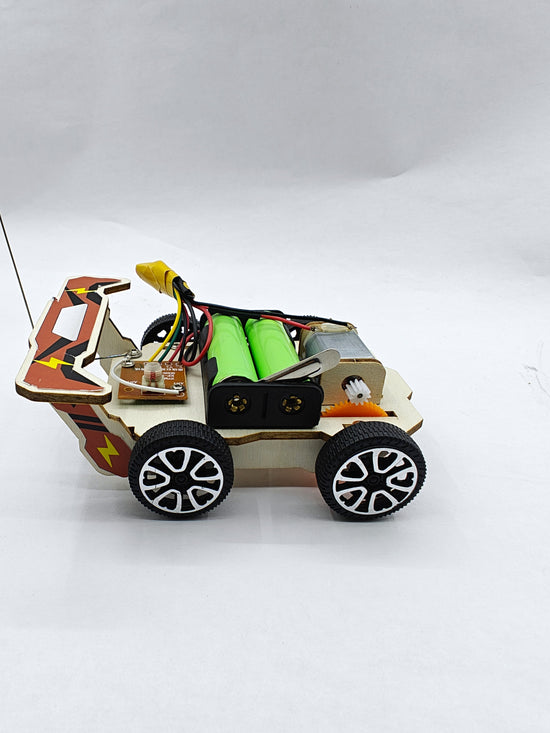 Wood Racer V1 RC car side view — laser-cut wooden car body and gear drive